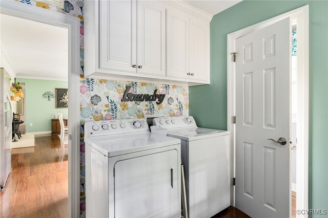 12387 Hanover Courthouse Rd, Hanover, VA 23069 - laundry area featuring washing machine and clothes dryer, cabinet space, ornamental molding, dark wood-style floors, and baseboards