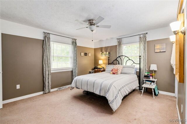12387 Hanover Courthouse Rd, Hanover, VA 23069 - bedroom with multiple windows, light colored carpet, baseboards, ceiling fan, and a textured ceiling