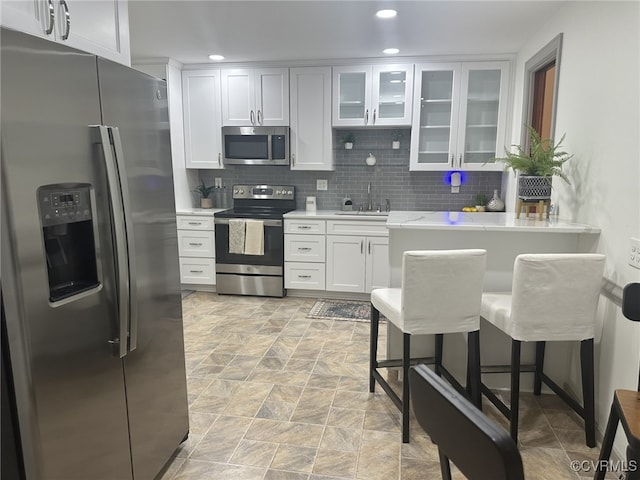 9079 Cudlipp Ave, Mechanicsville, VA 23116 - kitchen with stainless steel appliances, a sink, light countertops, white cabinetry, and recessed lighting