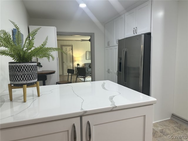 9079 Cudlipp Ave, Mechanicsville, VA 23116 - kitchen featuring stainless steel fridge, white cabinets, light stone countertops, and baseboards