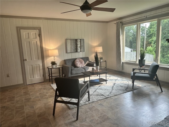 9079 Cudlipp Ave, Mechanicsville, VA 23116 - living area featuring crown molding, ceiling fan, stone finish floors, wooden walls, and baseboards