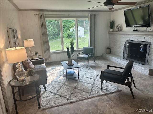 9079 Cudlipp Ave, Mechanicsville, VA 23116 - living area with crown molding, ceiling fan, a fireplace with raised hearth, wood walls, and stone finish floors