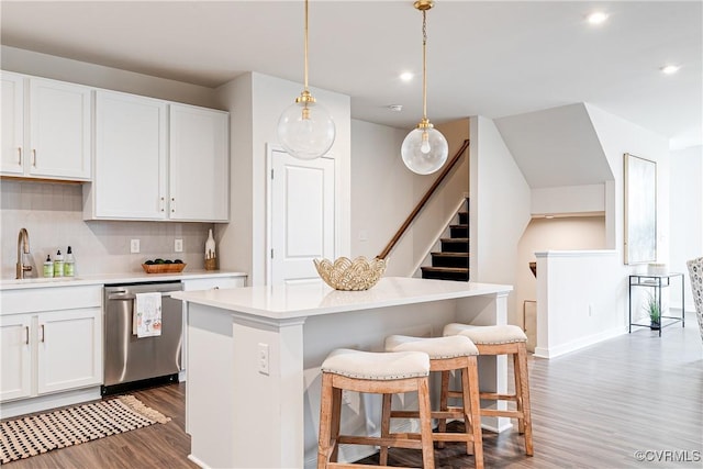 1900 Roseneath Rd Unit 9A, Richmond, VA 23230 - kitchen with dishwasher, a sink, wood finished floors, a kitchen island, and light countertops