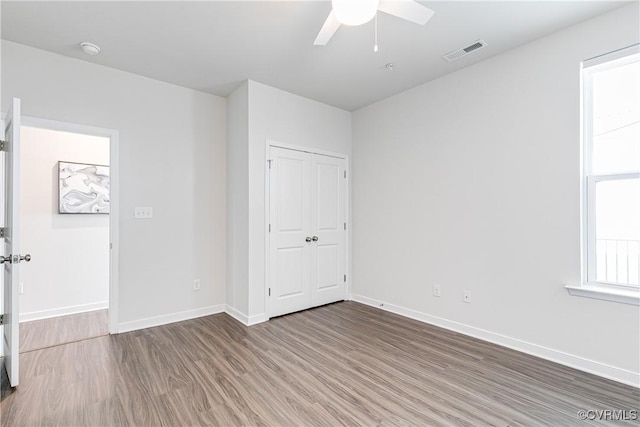 1900 Roseneath Rd Unit 9A, Richmond, VA 23230 - unfurnished bedroom with wood finished floors, baseboards, a closet, and ceiling fan