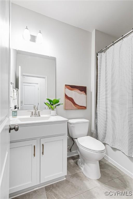 1900 Roseneath Rd Unit 9A, Richmond, VA 23230 - full bath featuring vanity, toilet, tile patterned flooring, shower / bath combination with curtain, and baseboards