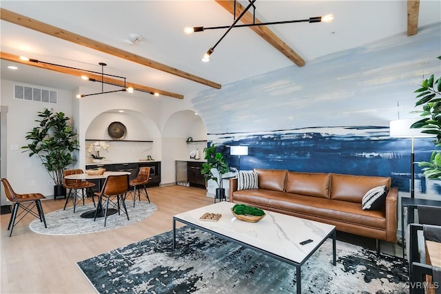 1900 Roseneath Rd Unit 9A, Richmond, VA 23230 - living area featuring beamed ceiling, wood finished floors, arched walkways, baseboards, and a chandelier