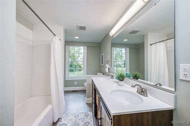 524 Highland Ave, Colonial Heights, VA 23834 - full bath with double vanity, toilet, shower / bathtub combination with curtain, tile patterned flooring, and baseboards