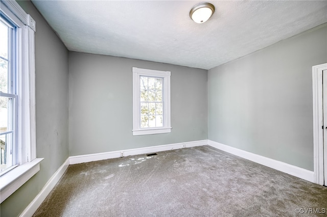 524 Highland Ave, Colonial Heights, VA 23834 - carpeted spare room featuring baseboards and a textured ceiling