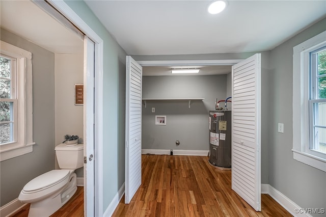 524 Highland Ave, Colonial Heights, VA 23834 - clothes washing area with washer hookup, water heater, wood finished floors, and baseboards