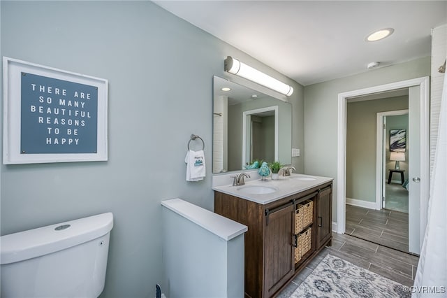524 Highland Ave, Colonial Heights, VA 23834 - full bathroom with toilet, baseboards, wood tiled floors, double vanity, and recessed lighting
