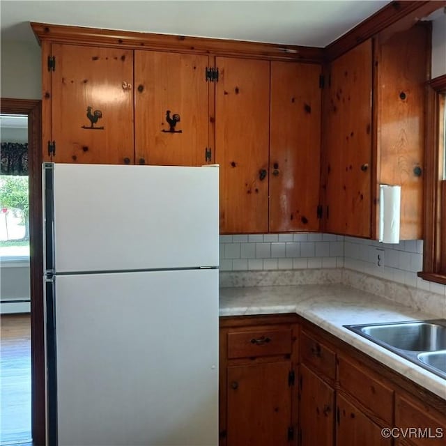 4846 Stanley Dr, Chesterfield, VA 23234 - kitchen with freestanding refrigerator, brown cabinets, light countertops, and decorative backsplash