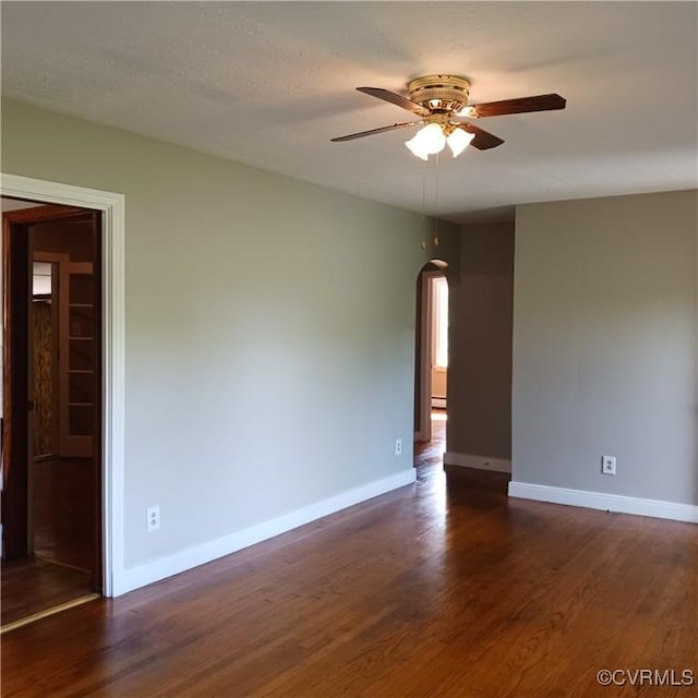 4846 Stanley Dr, Chesterfield, VA 23234 - unfurnished room featuring ceiling fan, arched walkways, dark wood-style flooring, and a baseboard heating unit