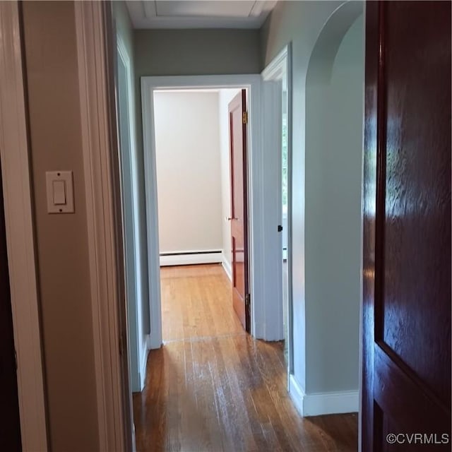 4846 Stanley Dr, Chesterfield, VA 23234 - hallway with wood finished floors, arched walkways, and a baseboard radiator