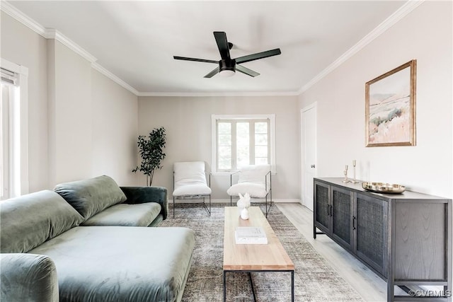 living room with light wood finished floors, ceiling fan, ornamental molding, and baseboards