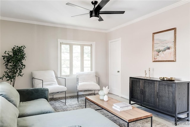 living room with light wood-type flooring, crown molding, ceiling fan, and baseboards