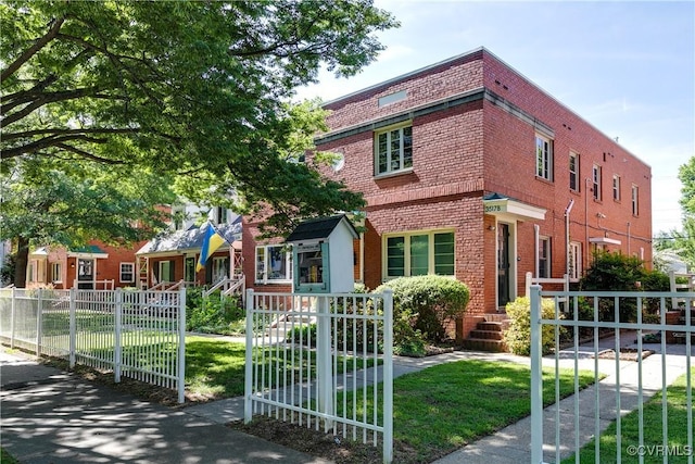 view of front facade with brick siding and a gate