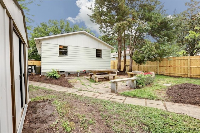 1909 N 28th St, Richmond, VA 23223 - back of property featuring board and batten siding and a fenced backyard