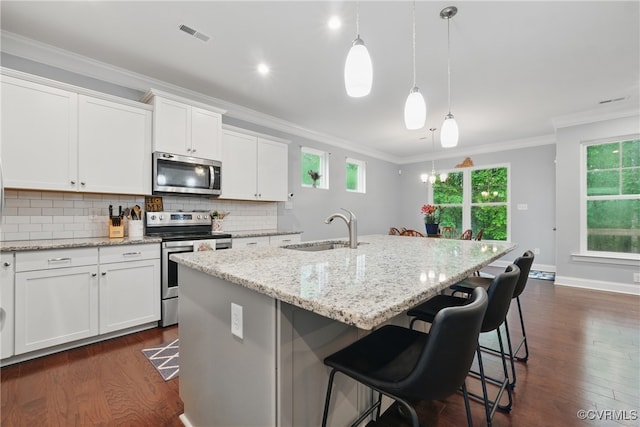 5681 Saint Leger Dr, Providence Forge, VA 23140 - kitchen with stainless steel appliances, a sink, dark wood-style floors, an island with sink, and tasteful backsplash
