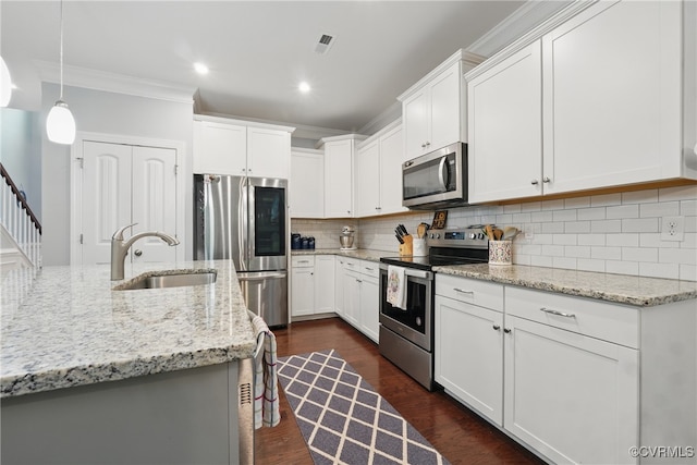 5681 Saint Leger Dr, Providence Forge, VA 23140 - kitchen featuring appliances with stainless steel finishes, a sink, ornamental molding, backsplash, and white cabinets