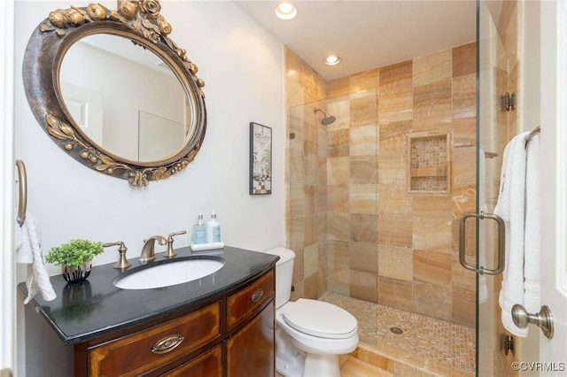 full bathroom with a shower stall, toilet, recessed lighting, and vanity