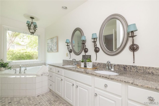 full bath featuring double vanity, a bath, and tile patterned flooring