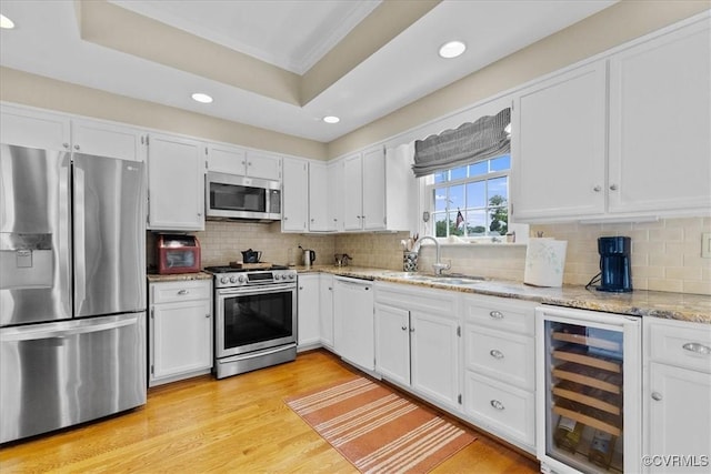 104 Peter Francisco Dr, Hopewell, VA 23860 - kitchen featuring appliances with stainless steel finishes, beverage cooler, a sink, recessed lighting, and light stone countertops
