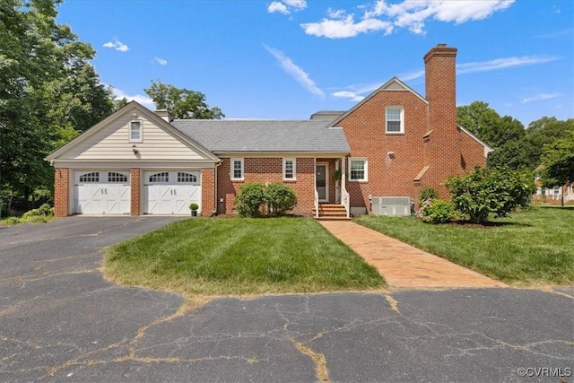 104 Peter Francisco Dr, Hopewell, VA 23860 - view of front of home with an attached garage, a chimney, driveway, brick siding, and a front lawn