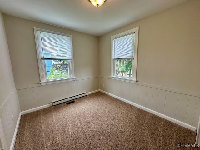 2404 Parrish St, Henrico, VA 23231 - carpeted empty room featuring a baseboard heating unit, plenty of natural light, and a wainscoted wall