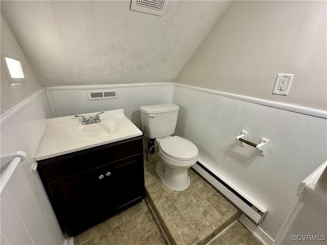 2404 Parrish St, Henrico, VA 23231 - bathroom with a baseboard heating unit, toilet, vaulted ceiling, vanity, and a wainscoted wall