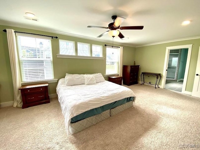 bedroom with ornamental molding, light colored carpet, baseboards, ceiling fan, and connected bathroom