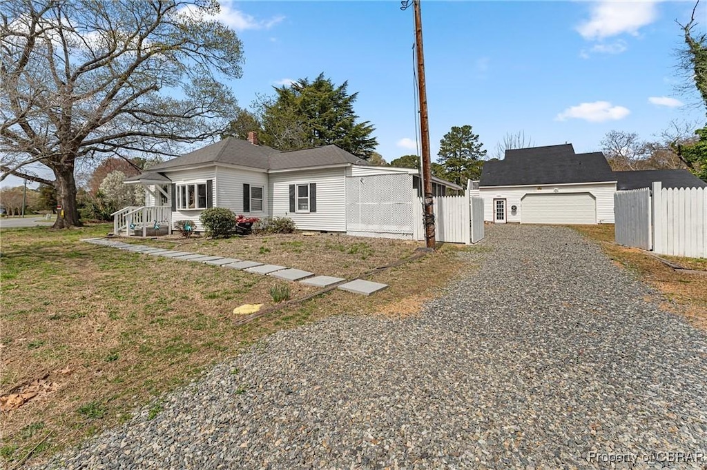 6827 Williams Landing Rd, Hayes, VA 23072 - view of front of house featuring a garage and gravel driveway