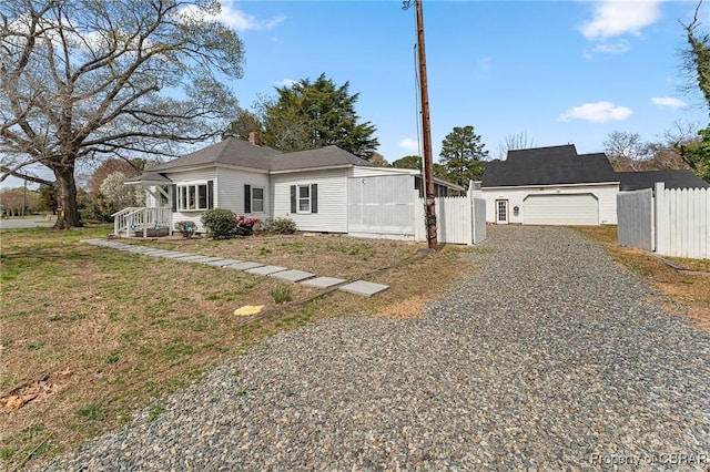 6827 Williams Landing Rd, Hayes, VA 23072 - view of front of house featuring a garage and gravel driveway