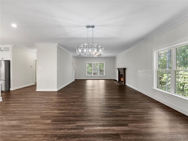 1280 Mill Quarter Rd, Powhatan, VA 23139 - unfurnished living room featuring a chandelier, ornamental molding, dark wood finished floors, and a warm lit fireplace