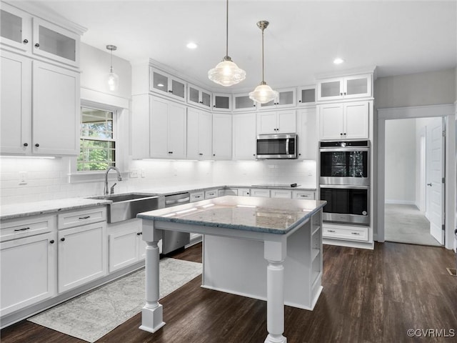 1280 Mill Quarter Rd, Powhatan, VA 23139 - kitchen with appliances with stainless steel finishes, dark wood-style flooring, white cabinetry, a center island, and recessed lighting