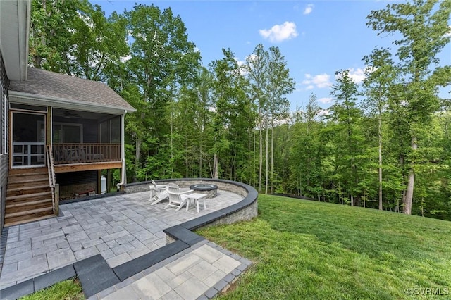1280 Mill Quarter Rd, Powhatan, VA 23139 - view of green lawn with a sunroom, a patio area, a fire pit, and a wooded view