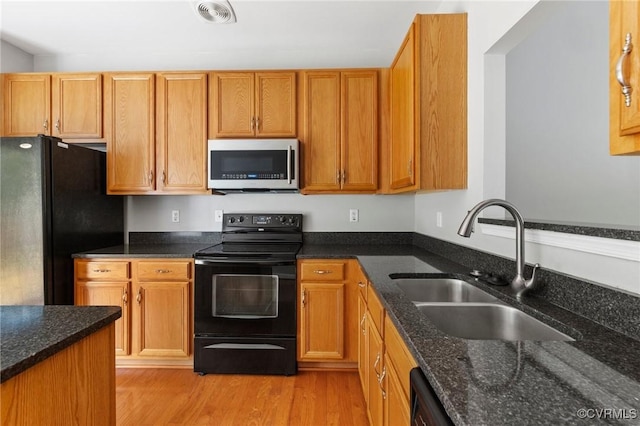 2409 Silver Lake Ter, Midlothian, VA 23112 - kitchen with black appliances, a sink, light wood finished floors, and dark stone countertops
