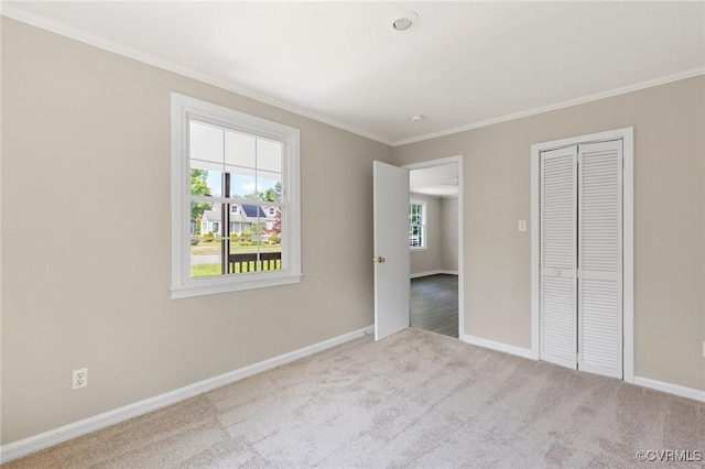 3507 Howard Rd, Henrico, VA 23223 - unfurnished bedroom with baseboards, crown molding, carpet flooring, and a closet