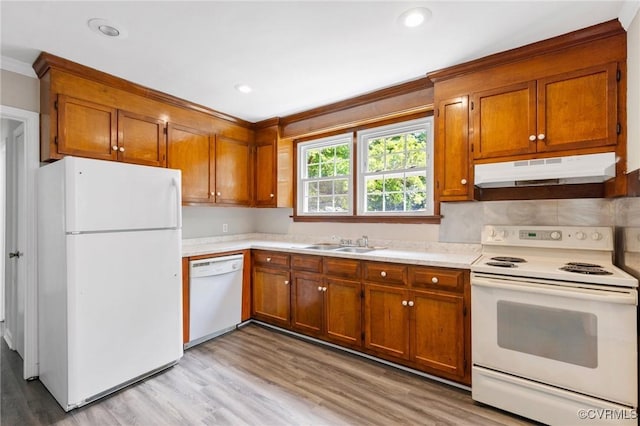 3507 Howard Rd, Henrico, VA 23223 - kitchen with white appliances, under cabinet range hood, a sink, brown cabinets, and light countertops