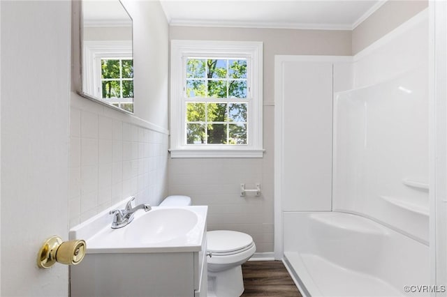 3507 Howard Rd, Henrico, VA 23223 - bathroom with tile walls, vanity, a shower, wood finished floors, and toilet