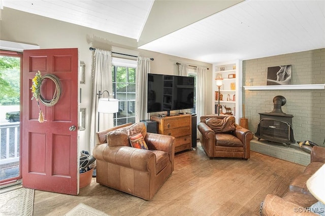 15019 Quaker Church Rd, Montpelier, VA 23192 - living room featuring light wood finished floors, a wood stove, lofted ceiling, and built in shelves