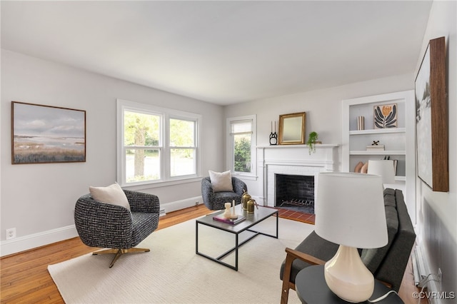 701 Nottoway Ave, Blackstone, VA 23824 - living room with a fireplace, baseboards, and wood finished floors