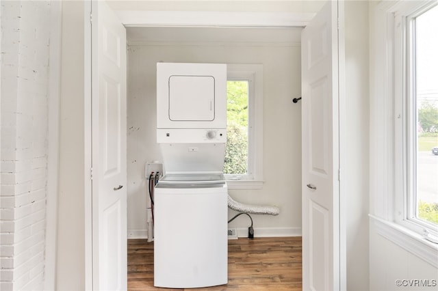 701 Nottoway Ave, Blackstone, VA 23824 - laundry area with stacked washing machine and dryer, wood finished floors, healthy amount of natural light, and baseboards