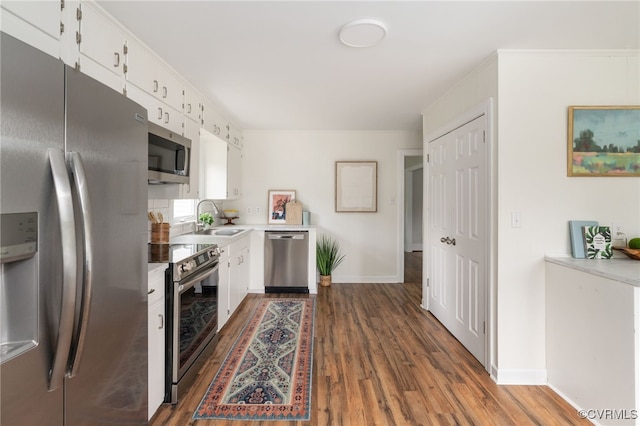 701 Nottoway Ave, Blackstone, VA 23824 - kitchen featuring stainless steel appliances, a sink, dark wood-type flooring, white cabinets, and light countertops