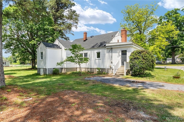 701 Nottoway Ave, Blackstone, VA 23824 - back of house featuring a chimney, a lawn, entry steps, and a shingled roof