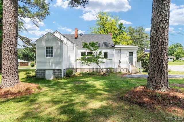 701 Nottoway Ave, Blackstone, VA 23824 - back of property with a chimney, entry steps, roof with shingles, and a yard