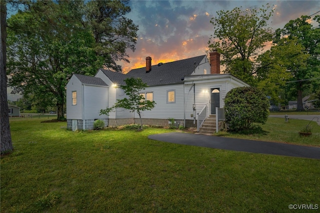 701 Nottoway Ave, Blackstone, VA 23824 - view of front of house featuring a chimney, a front lawn, and a shingled roof