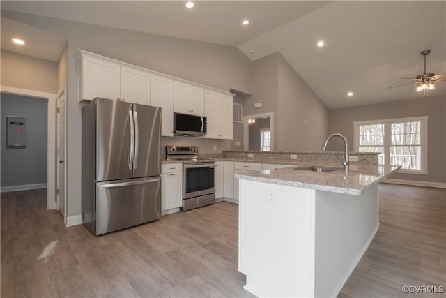 4373 Shannon Hill Rd, Columbia, VA 23038 - kitchen with stainless steel appliances, a sink, baseboards, white cabinetry, and high vaulted ceiling