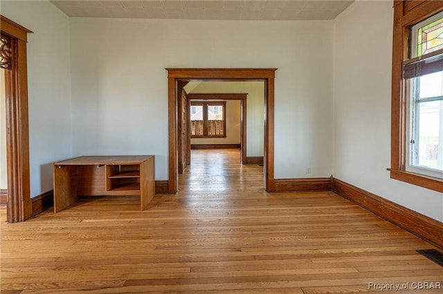89 N Main St, Kilmarnock, VA 22482 - unfurnished room featuring baseboards, plenty of natural light, and light wood finished floors