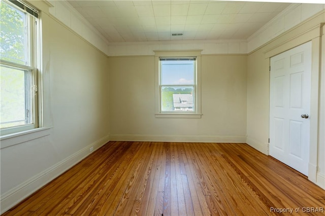 89 N Main St, Kilmarnock, VA 22482 - unfurnished room featuring hardwood / wood-style floors, plenty of natural light, baseboards, and ornamental molding