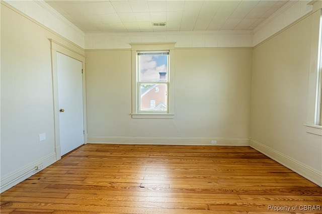 89 N Main St, Kilmarnock, VA 22482 - empty room with light wood finished floors, ornamental molding, and baseboards